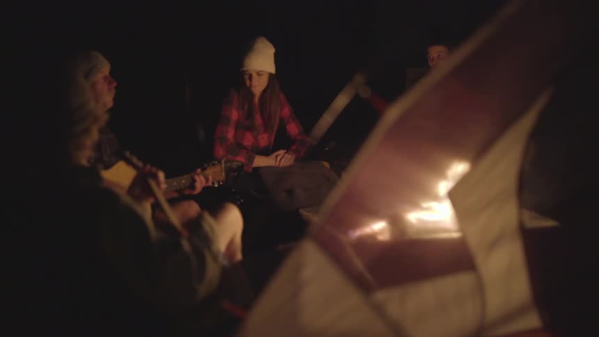 A group of friends sitting around a campfire