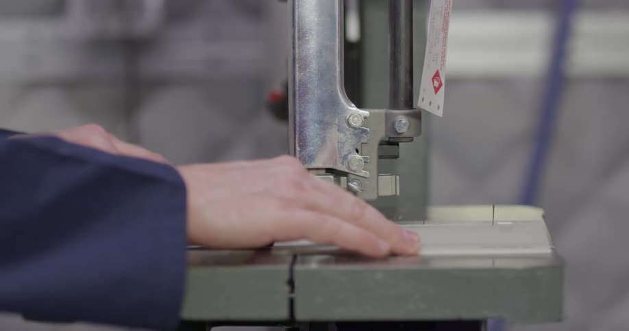 Person using a saw to saw an object