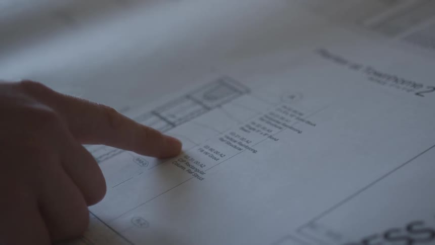 A person looking at engineering schematics