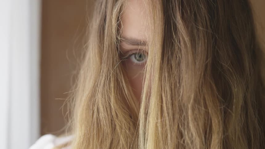 A woman with hair over her face