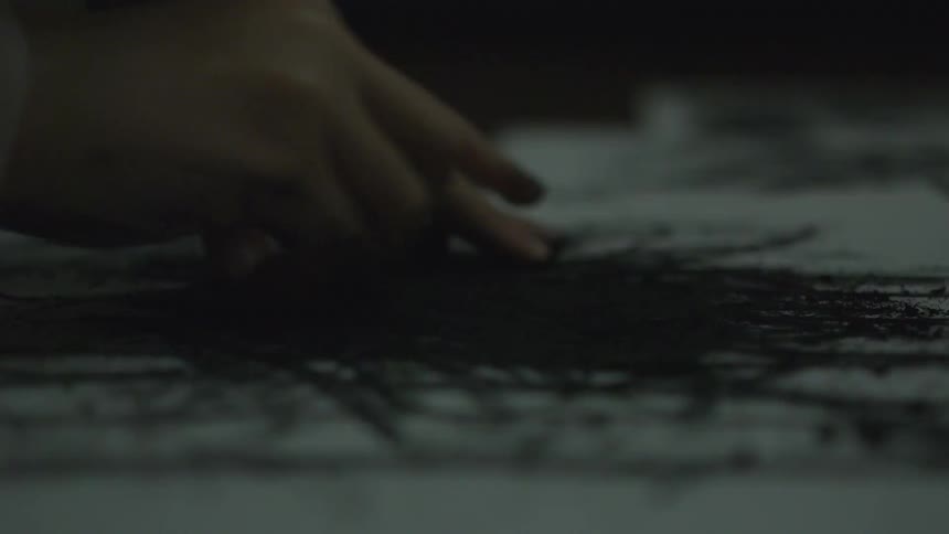 Someone is drawing on a piece of paper