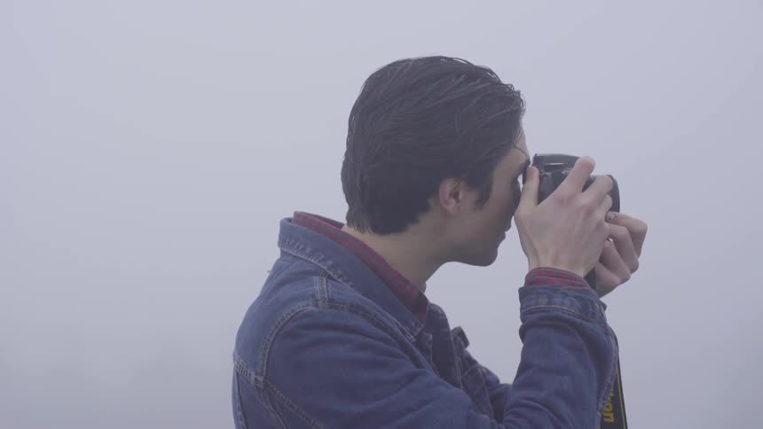 On a foggy day a man takes a picture
