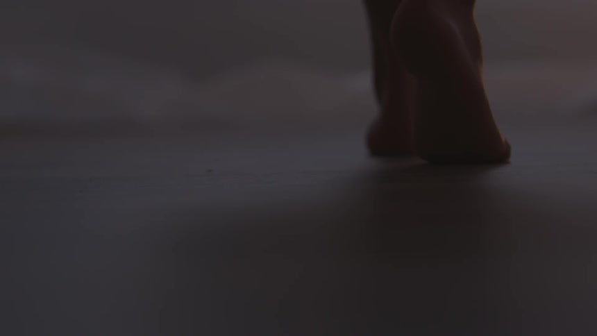 A woman walking barefoot on a floor