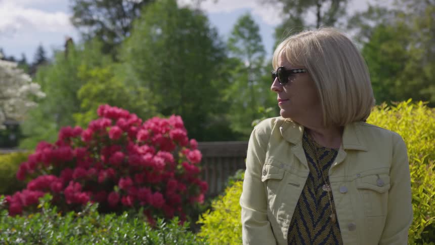 A woman sitting out in a garden