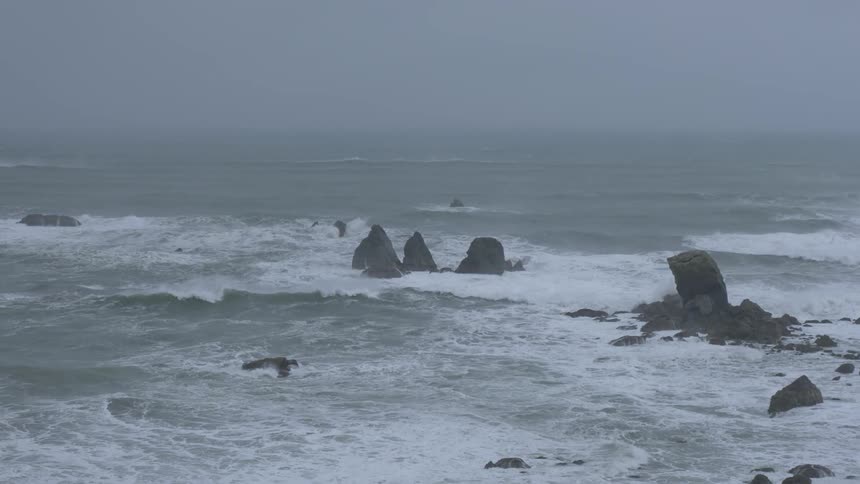 Waves are crashing by the rocks