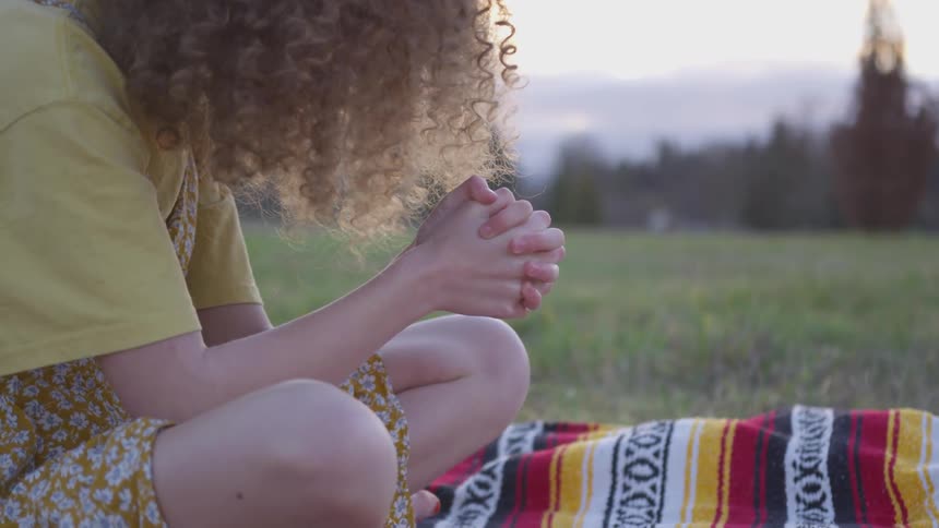 Girl Reading A Bible And Walking In A Field