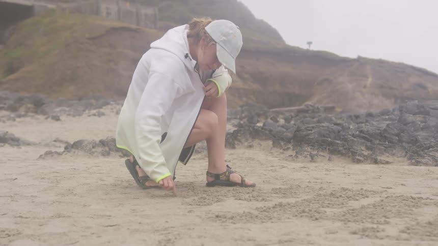 Girl At A Beach On A Cloudy Day