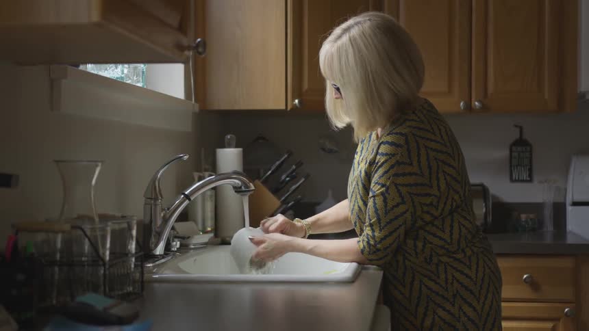 A woman washing dishes