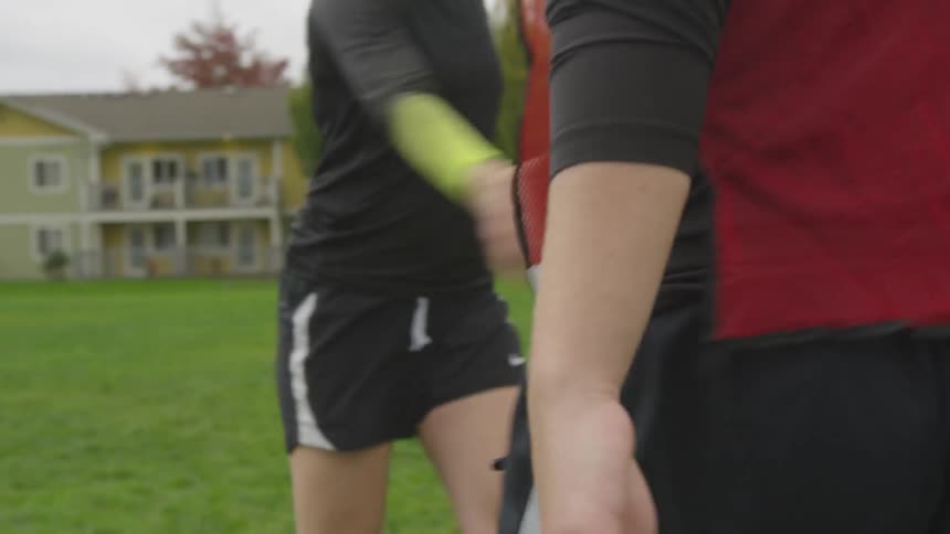 Athletes shake hands on the field