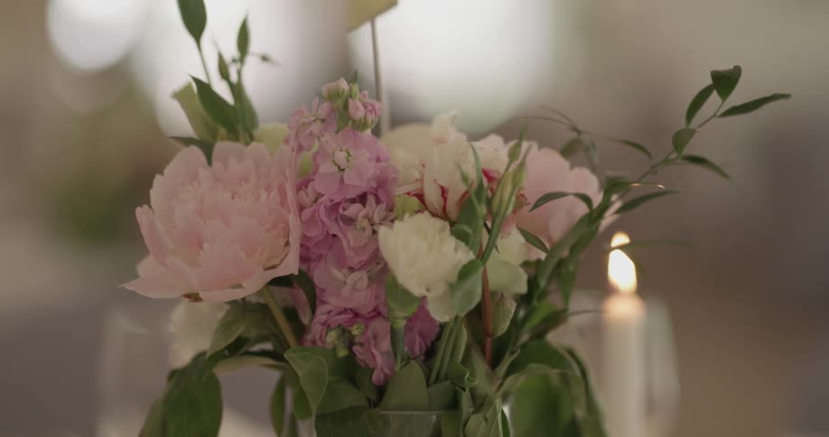 Bouquet of flowers next to a candle
