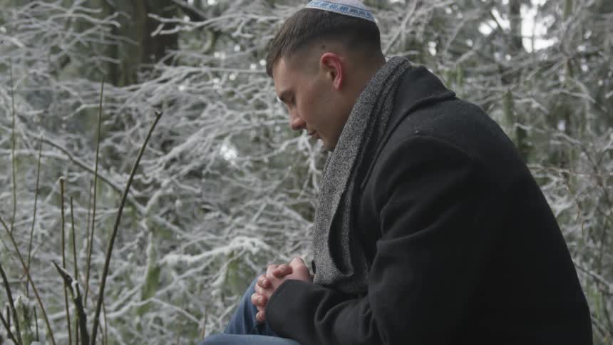 Man sits in the woods and prays