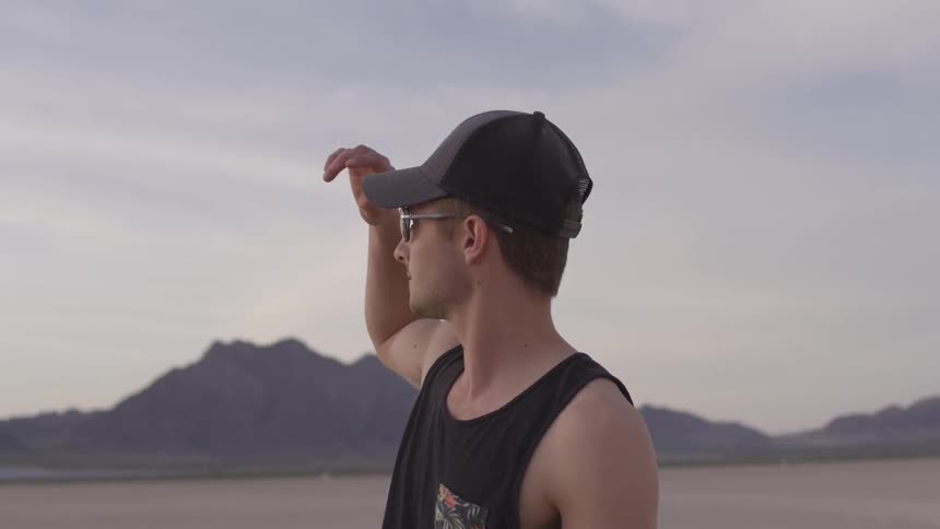 Man in hat looks towards the horizon