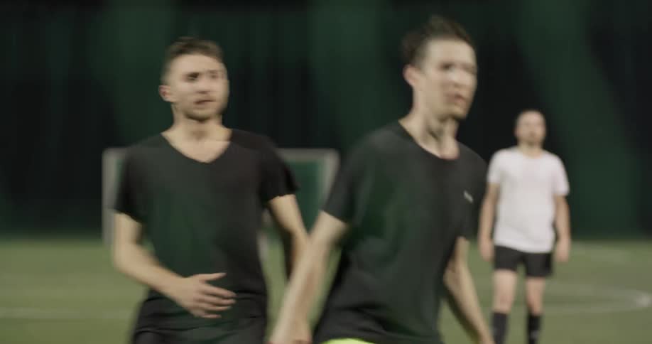 A man raises his hand to call for the soccer ball