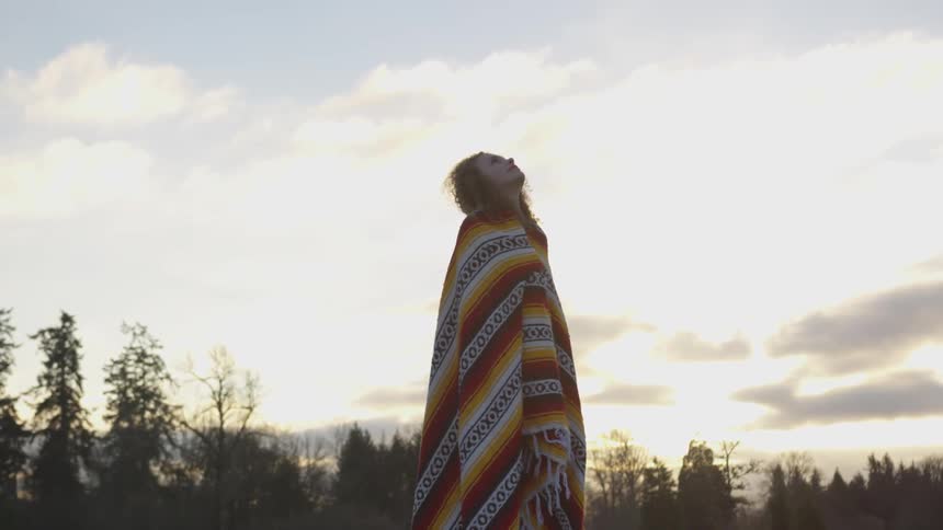 Girl Reading A Bible And Walking In A Field