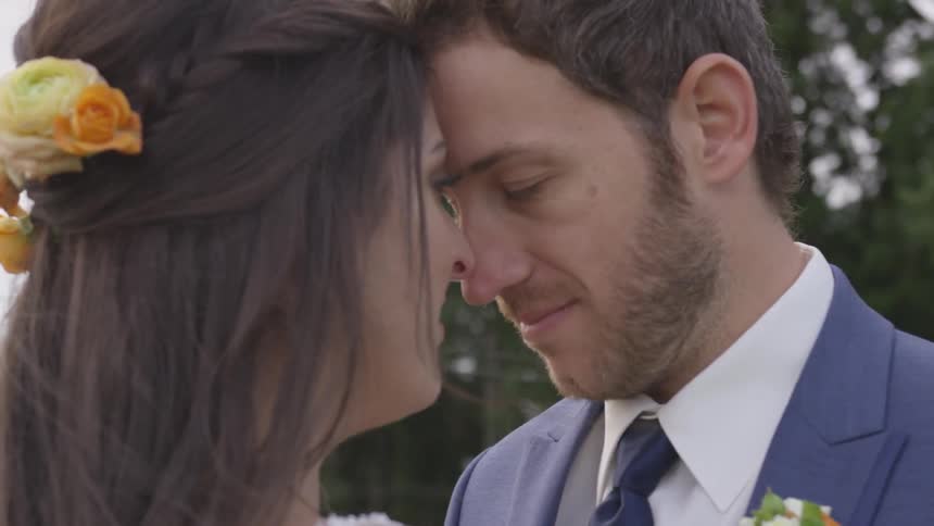 A man and woman kissing each other outdoors