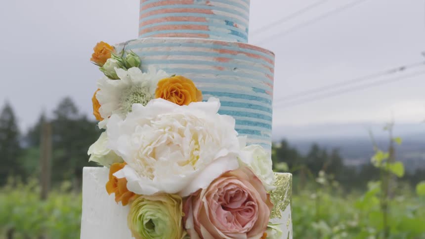 There is a tall cake outside