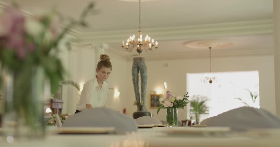 A woman is putting items on a table