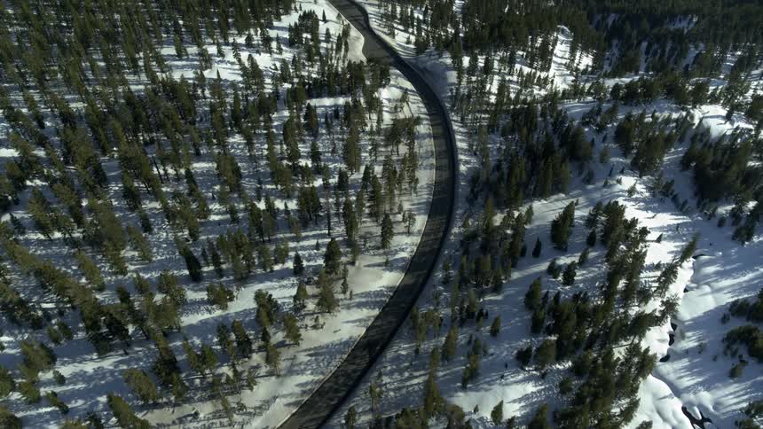 A road that runs through a snowy mountain range