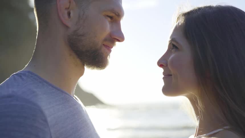 Man and woman hug and woman kisses man's forehead