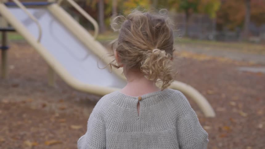 A young girl plays on the playground