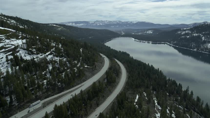 A long curved road goes around the mountain