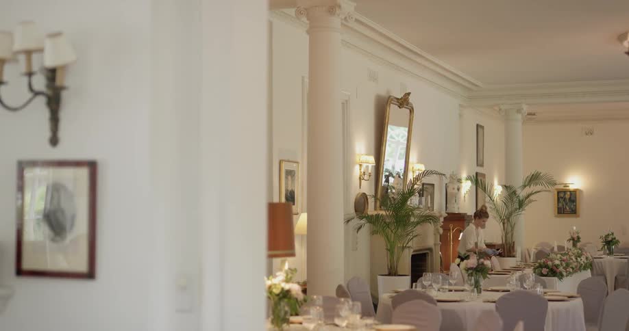 A woman is arranging a dining table
