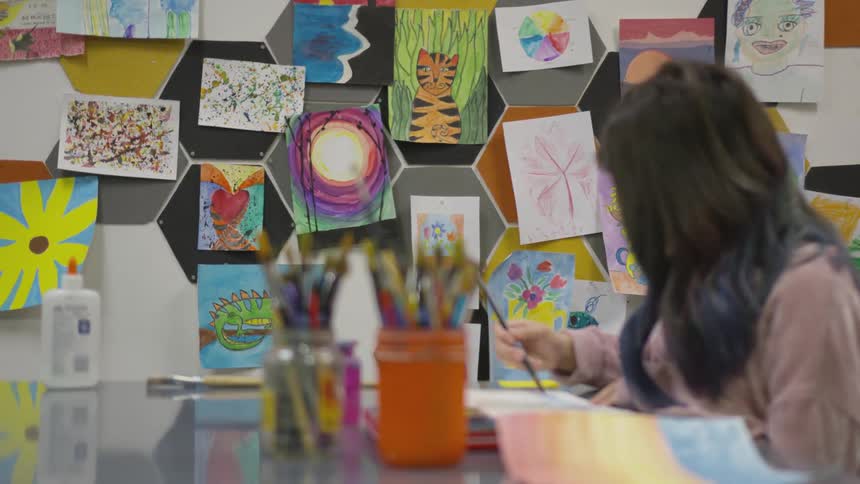 A child sits at a table painting