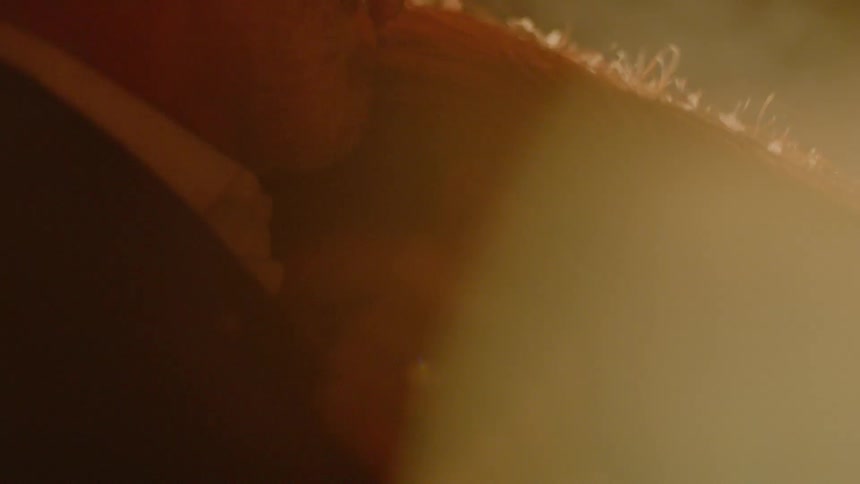 A man and woman are smiling at each other