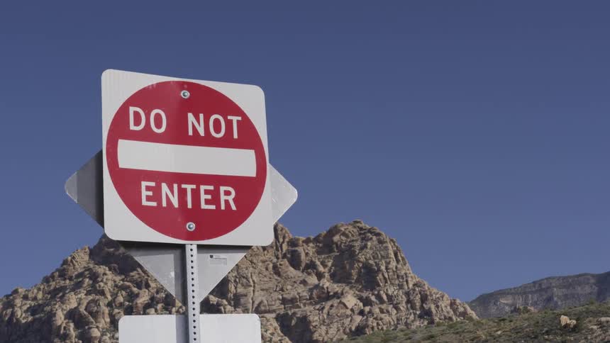 Do not enter sign in front of large rock