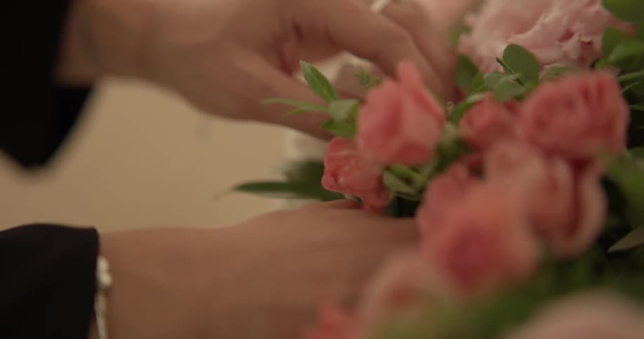 A woman grabbing roses out of a bunch