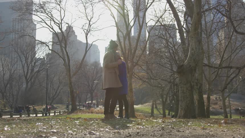 Two people hug in the park