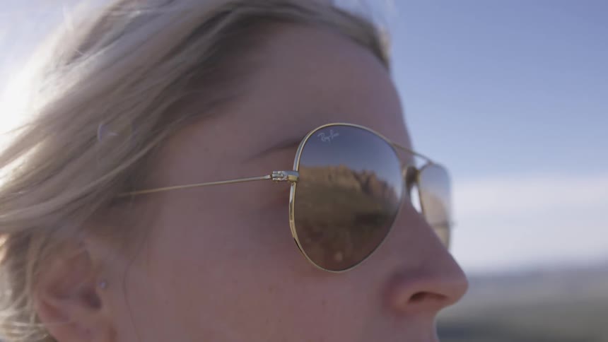 Blond woman in sunglasses with breeze blowing hair