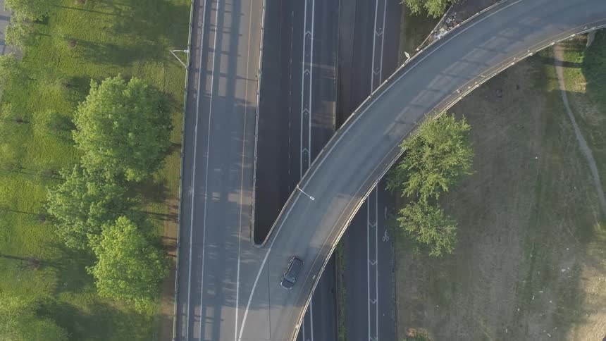 A car drives along an on ramp to a freeway
