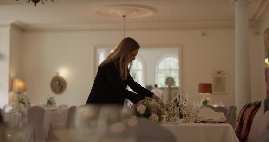 A woman putting drinks on a table