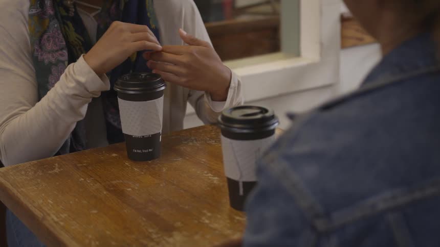 Two women drinking coffee at a cafe