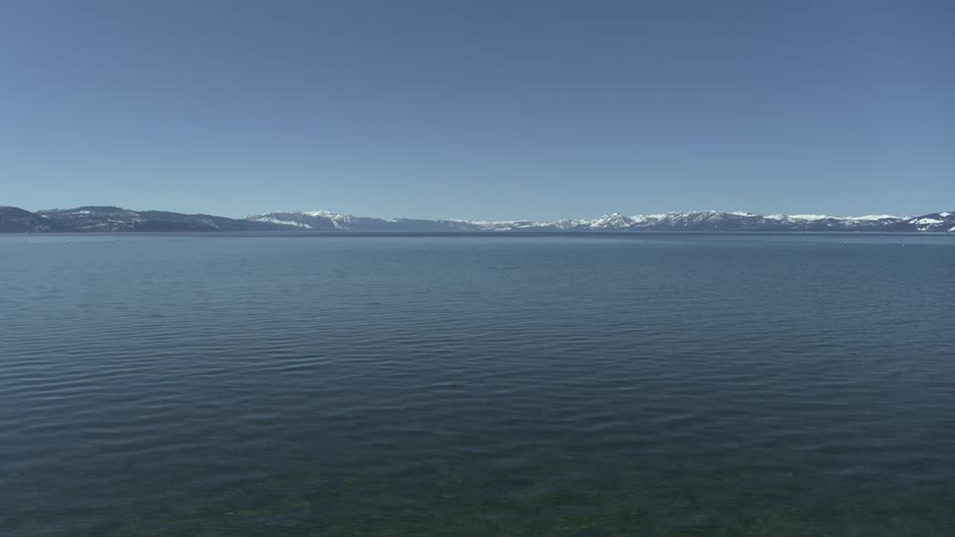 A view of a large lake near some mountains