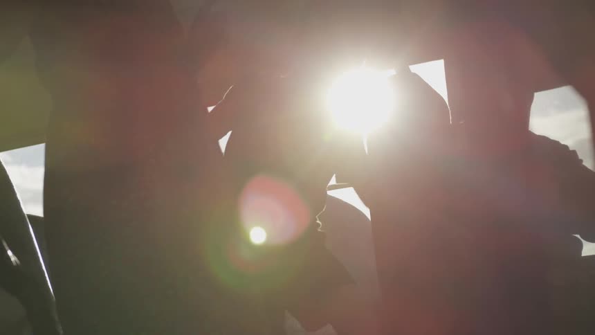 A child rushes to find a seat on a bus as the sun streams through the vehicle's windows