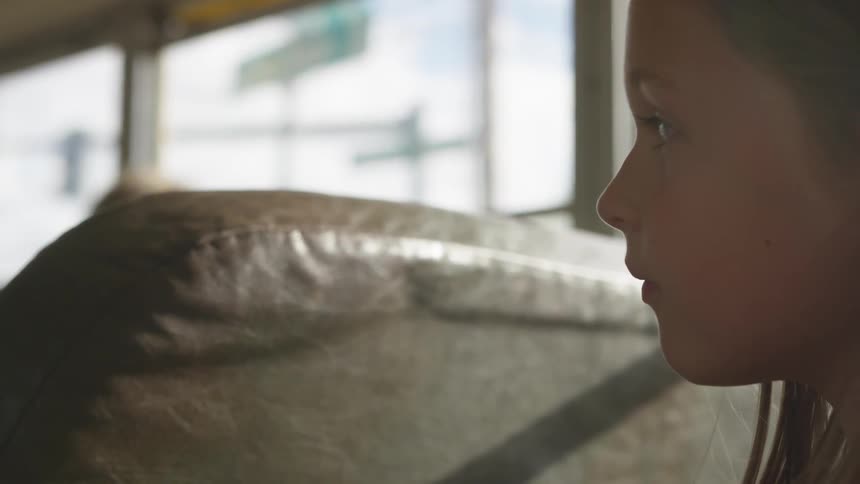 A child looks around on the school bus