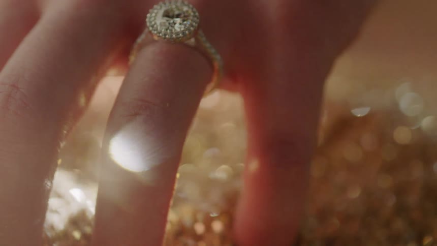 A woman is wearing a ring on her finger