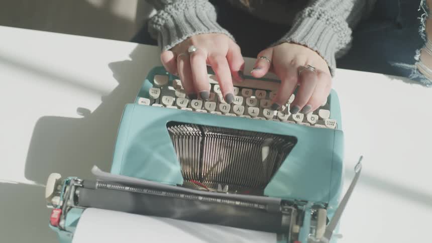 Woman working at a teal typewriter