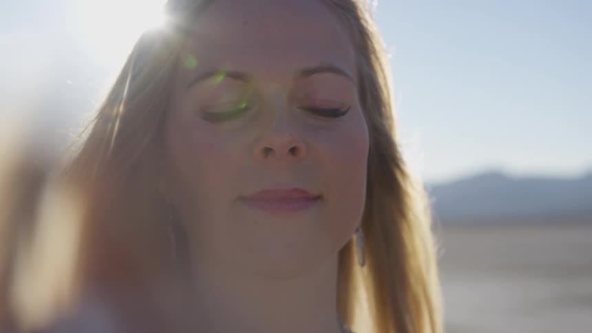 A woman enjoying the sun with her eyes closed