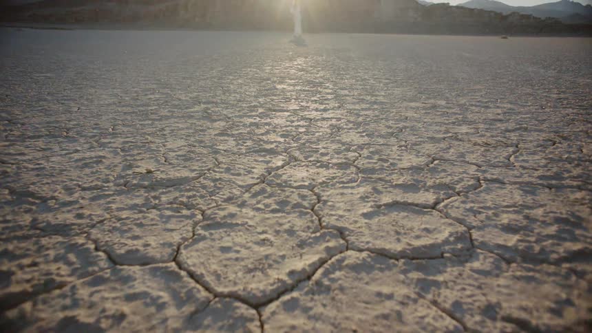 A woman is in the background of a desert