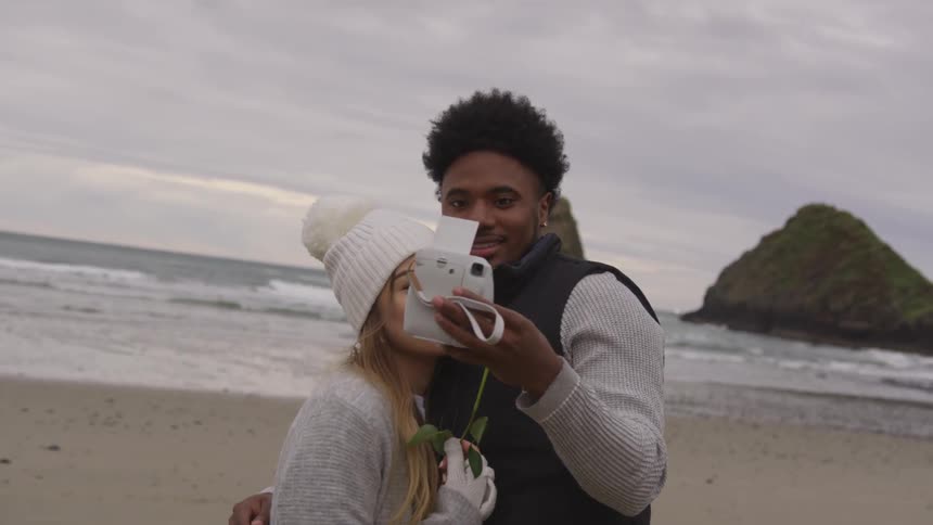 Couple take selfie by the ocean