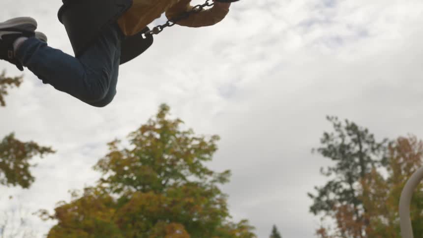 Person is swinging on a park swing