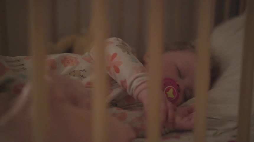 Baby sleeps in a crib