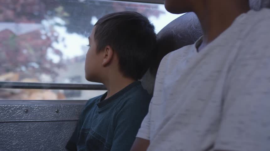 Children sitting on a bus in a city