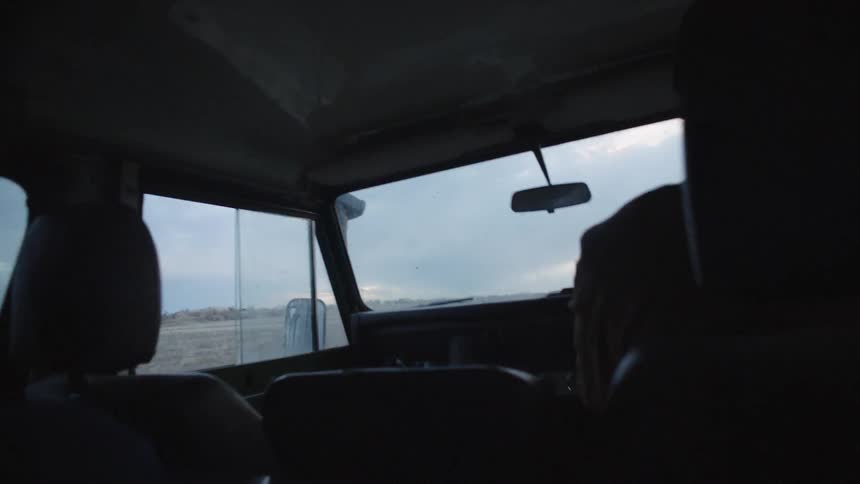 A person is driving a car during daylight