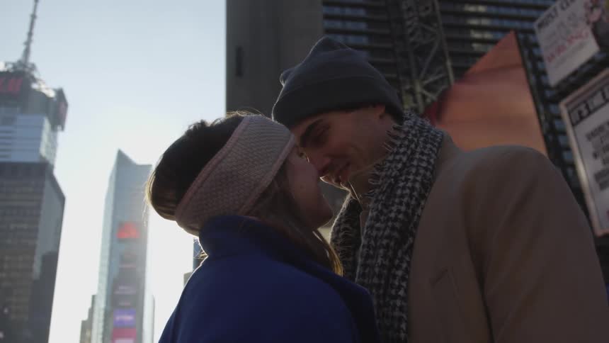 Man and woman staring at each other in a city