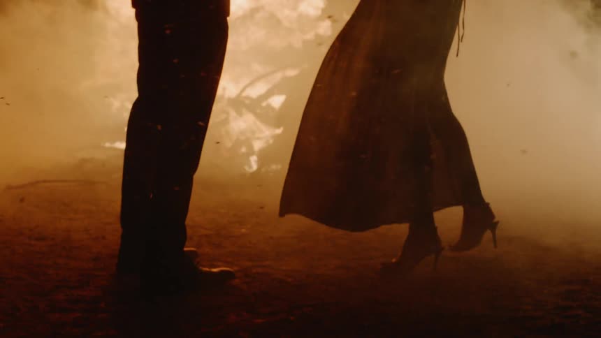 Man and a woman dancing surrounded by ash and fire