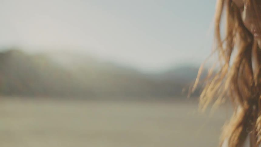 A woman with blond hair blowing in the wind